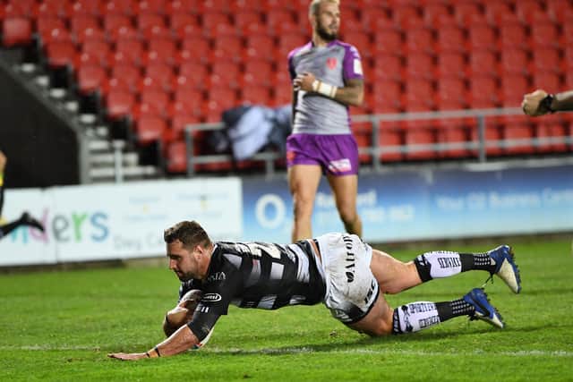 Hull FC's Josh Bowden dives over for the opening try against Hull KR. Picture: Jonathan Gawthorpe/JPIMedia.