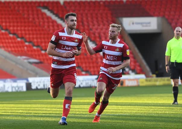 Doncaster's Ben Whiteman celebartes his goal with Josh Sims. Picture: Howard Roe
