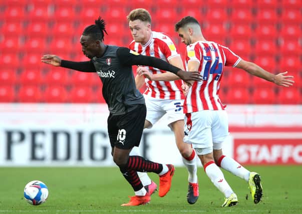 Breaking: Rotherham United's Freddie Ladapo gets away from  Stoke City's Tommy Smith. Picture: PA