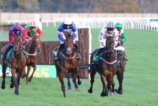 Cyrname (centre) travels with ominous ease down the Wetherby back straight under Harry Cobden. Photo: Phill Andrews.