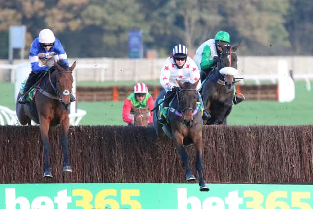 Aye Right and Callum Bewley (centre) lead Harry Cobden and Cyrname (left) down the Wetherby back straight. Photo: Phill Andrews.