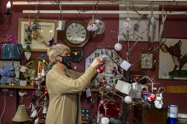 Sue Wood at Streetwise shop and laundrette in Hawes decorates a tree of life with Christmas decorations to raise money for  Christopher Riley before the upcoming lockdown. Picture: Tony Johnson