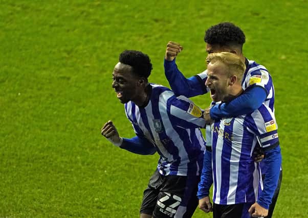 Sheer relief: Sheffield Wednesday’s Barry Bannan celebrates his match-winning penalty against Bournemouth with Moses Odubajo, left, and Elias Kachunga.   Picture: Zac Goodwin/PA