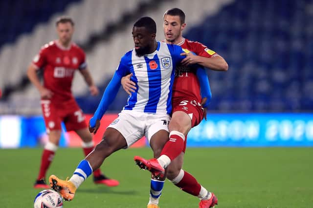 Huddersfield Town's Isaac Mbenza (left) and Bristol City's Tommy Rowe battle for the ball at the John Smith's Stadium on Tuesday. Picture: Mike Egerton/PA