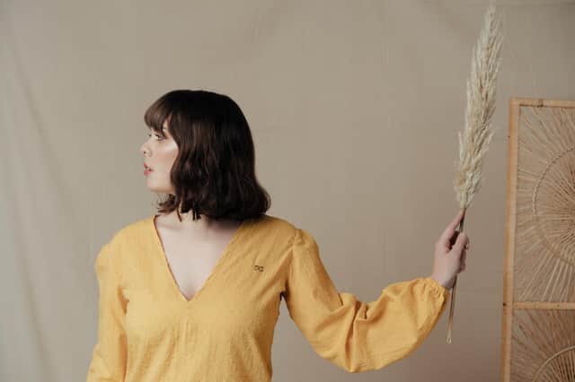 Edie Booth wears the Nyoo Fairport Top in mustard, £34, handmade in luxury fine lawn 100% cotton with a hand embroidered OO detail.