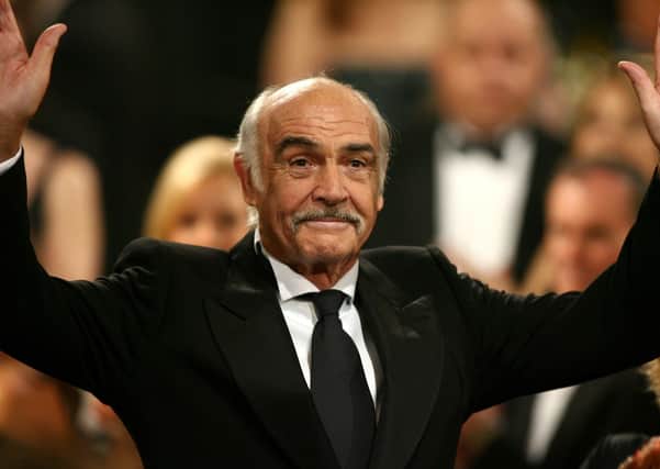 Sean Connery waves to the audience during the 34th AFI Life Achievement Award tribute to Sir Sean Connery held at the Kodak Theatre on June 8, 2006 in Hollywood, California.  (Photo by Kevin Winter/Getty Images for AFI)