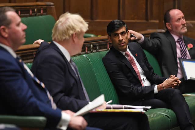 Boris Johnson and Rishi Sunak have a brief exchange in the House of Commons.