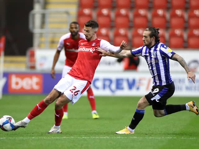 TOUGH TIMES: Rotherham United's Dan Barlaser (left) and Sheffield Wednesday's Jack Marriott battle for the ball in the recent South Yorkshire derby at the New York Stadium. Picture: Danny Lawson/PA