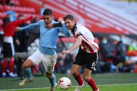 TOUGH GOING: Sheffield United's Chris Basham tussles with Manchester City's Ferran Torres at Bramall Lane last month. Picture: Simon Bellis/Sportimage
