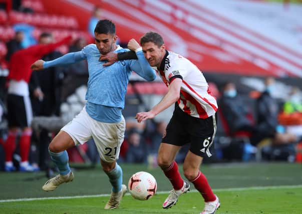 TOUGH GOING: Sheffield United's Chris Basham tussles with Manchester City's Ferran Torres at Bramall Lane last month. Picture: Simon Bellis/Sportimage