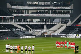 SILENCE: Players observe a minute of remembrance before kick-off. Picture: Alex Pantling/Getty Images.