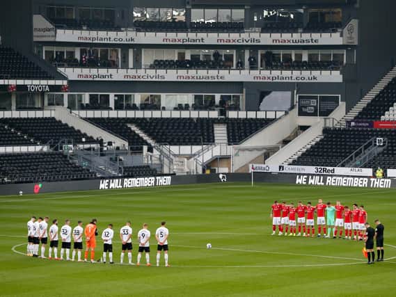 SILENCE: Players observe a minute of remembrance before kick-off. Picture: Alex Pantling/Getty Images.
