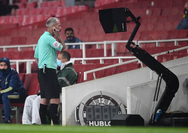 Referee Martin Atkinson: Consulting VAR before disallowing Aston Villa a goal for an offside decision against Ross Barkley against Arsenal. Picture: PA