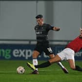 More than enough: Doncaster Rovers’ Ed Williams comfortably evades the challenge of a trailing FC United of Manchester leg as Andy Butler’s side marched into the second round. Picture: Howard Roe)