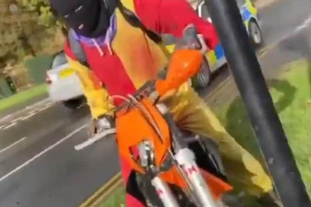 The same man was seen on a dirt bike wearing the clown suit and a black balaclava