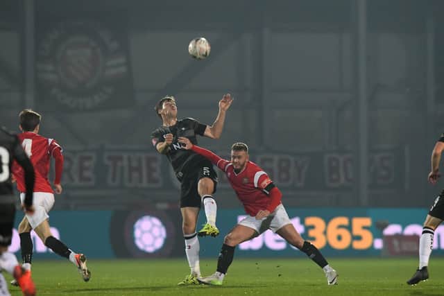 CUP CLASH: Doncaster Rovers' Joe Wright battles with FC United of Manchester's Paul Ennis. Picture: Howard Roe/AHPIX.com