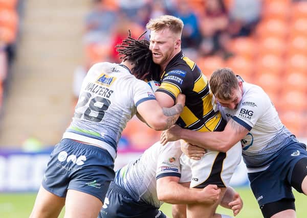 York's Perry Whiteley is tackled by Featherstone's Josh Walters.