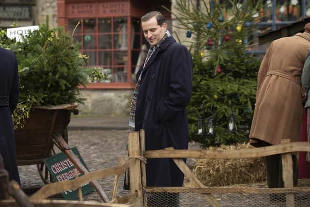 James (Nicholas Ralph) srrorunded by Christmas trees in Darrowby, portrayed in the C5 series by Grassington.