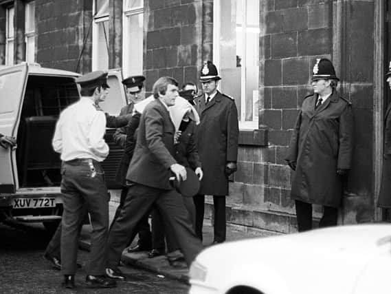 Peter Sutcliffe, under a blanket, arriving at Dewsbury Magistrates Court after he was eventually charged with the murder of 13 women and attempted murder of seven others