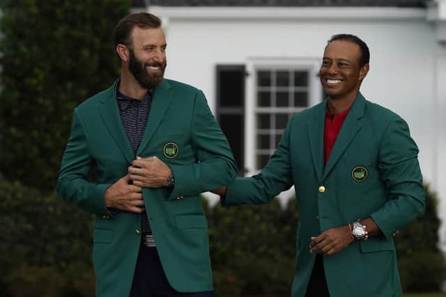 Well done: Last year's winner Tiger Woods stands next to Masters champion Dustin Johnson with his green jacket. (AP Photo/Chris Carlson)