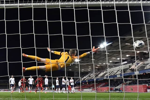 England's goalkeeper Jordan Pickford fails to stop the ball.