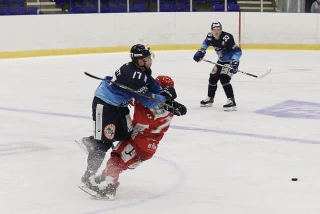 BIG HIT: Jason Hewitt delivers a mid-ice hit on Swindon player at Ice Sheffield on Sunday evening. Picture: Cerys Molloy.