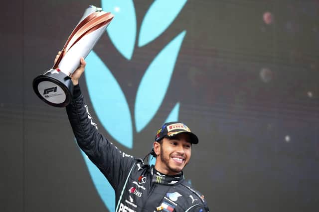 Lewis Hamilton celebrates after winning the Formula One Turkish Grand Prix (Tolga Bozoglu/Pool via AP)