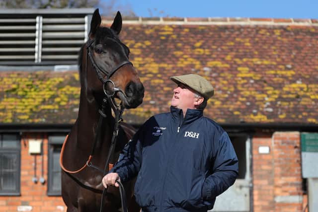 At home: Trainer Paul Nicholls poses for a photograph with Clan Des Obeaux in the yard at Ditcheat. Picture: Andrew Matthews/PA Wire
