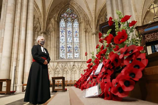 The Revd Maggie McLean, York Minster's Canon Missioner, observes a two minute silence in the Cathedral in York, to remember the war dead on Armistice Day. Photo: Danny Lawson/PA Wire
