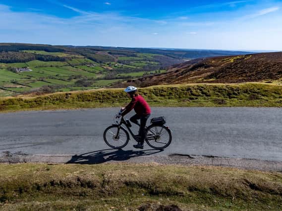 A cyclist pictured in Rosedale Chimney Bank between Rosedale Abbey and Hutton-le-Hole in the Ryedale district of the North York Moors National Park