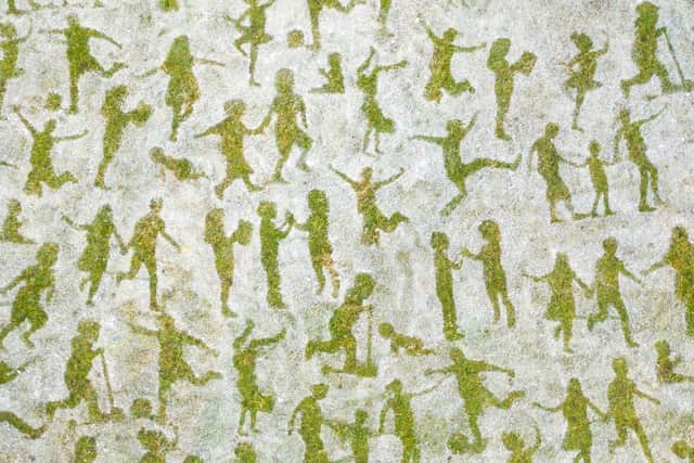 The team of artists, from Sand In Your Eye, have created a striking image made up of 6000 life size figures of playing children, that when viewed from the sky forms a childs face, in Hebden Bridge. Photo credit: Sand In Your Eye.