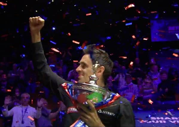 Ronnie O'Sullivan: Lifting the World Snooker Championship trophy at The Crucible, Sheffield. Picture: PA