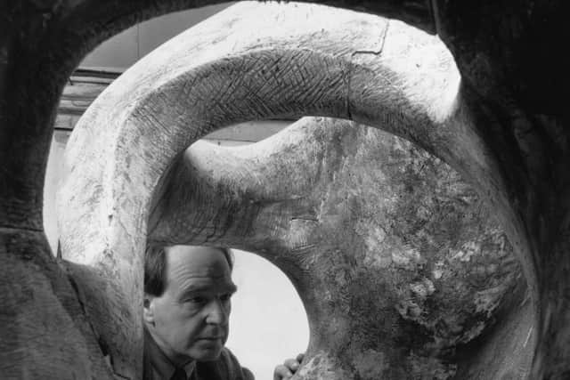 20th November 1953:  British sculptor Henry Moore (1896 - 1986) examines the interior of his massive sculpture Reclining Figure.  (Photo by Chris Ware/Keystone Features/Getty Images)