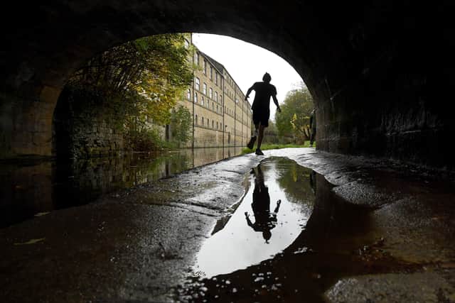 A runner on the Leeds and Liverpool canal at Kirkstall, Leeds