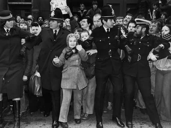 Police hold back large crowds outside Dewsbury court, awaiting Peter Sutcliffe's arrival. Many women lived in fear as he committed his crimes. Photo:Jack Hickes/Keystone/Hulton Archive/Getty Images