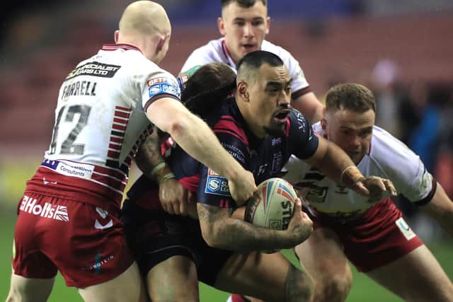 Hull FC's Mahe Fonua is tackled by Wigan Warriors' Liam Farrell (left), Oliver Gildart and Bevan French (Picture: PA).
