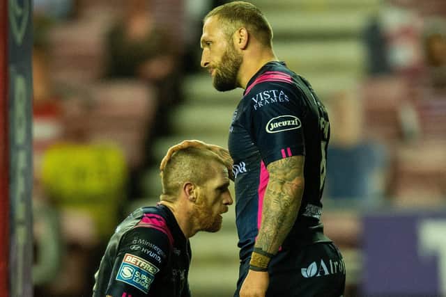 Marc Sneyd is consoled by Josh Griffin after losing grip of the ball just short of the line as Hull lost to Wigan (Picture: Bruce Rollinson)