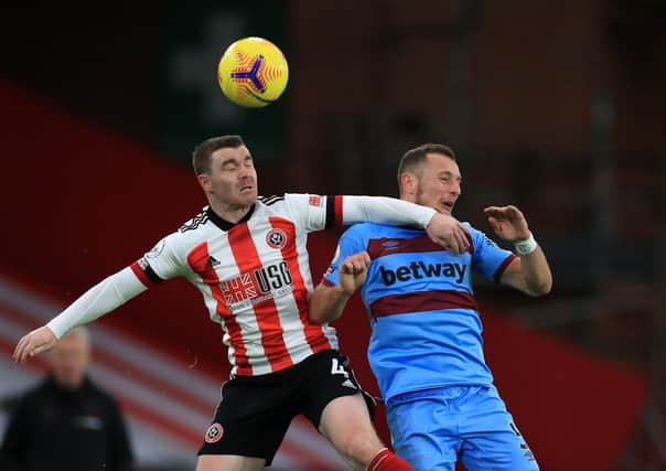 Returning to fray: Sheffield United's John Fleck and West Ham United's Vladimir Coufal battle for the ball. Picture: PA