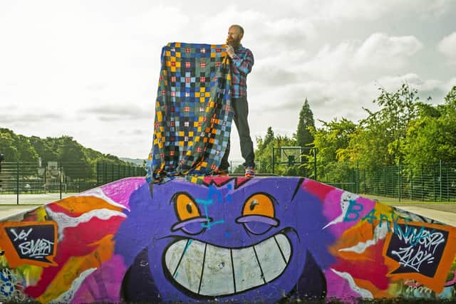 Huddersfield quilt maker Chris English at the skate park with one of his quilts. . Picture Tony Johnson
