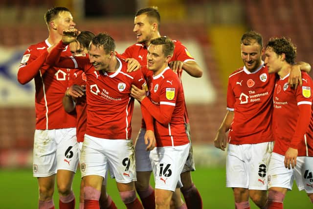 ON THE UP: Cauley Woodrow celebrates scoring Barnsley's second goal against Nottingham Forest at Oakwell on Saturday. Picture: Bruce Rollinson