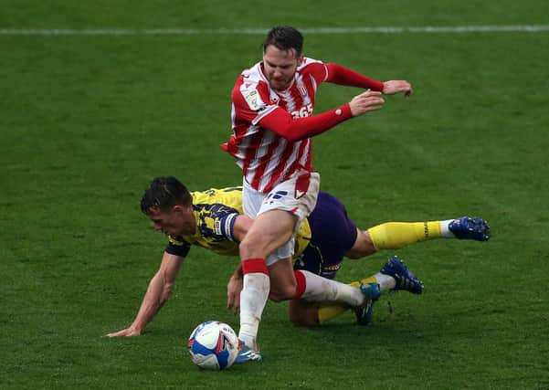 FATIGUE: Huddersfield Town's Jonathan Hogg battles with Stoke City's Nick Powell during the weekend's 4-3 defeat in the Potteries. Picture: Barrington Coombs/PA
