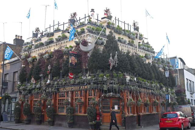 Christmas trees adorn the Churchill Arms in London ahead of the partial lifting of the lockdown.