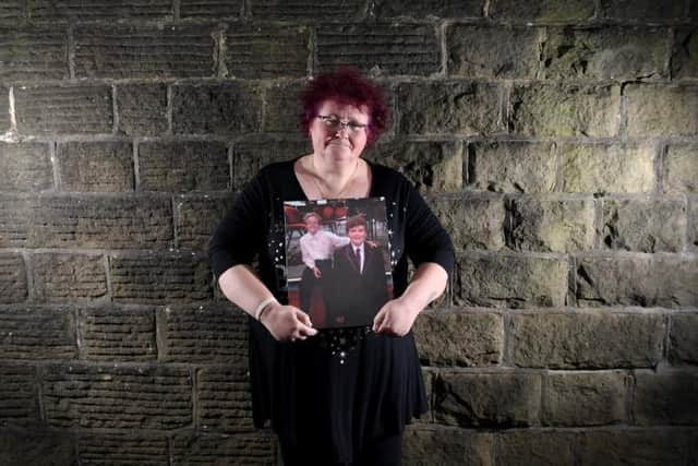 Domestic abuse survivor Claire Throssell with a picture of her sons Paul and Jack, who were murdered by their father Darren Sykes, Penistone