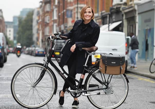 Olympic gold winning track cyclist Victoria Pendleton with her best-selling Somerby electric bike which is sold through Halfords