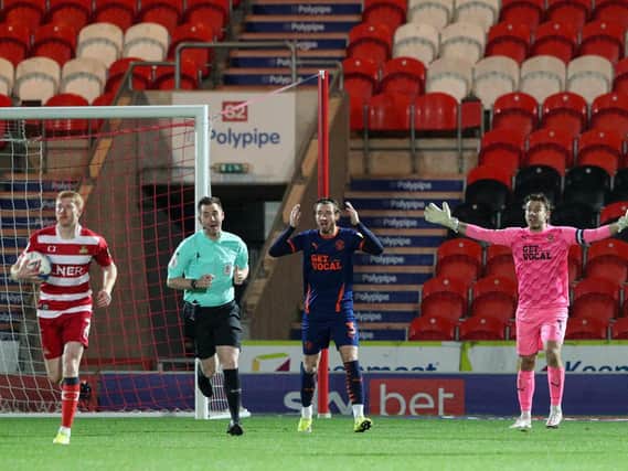 COMEBACK: Brad Halliday returns the ball to the centre circle as Blackpool complain about Cameron John's goal, which started the Doncaster Rovers comeback