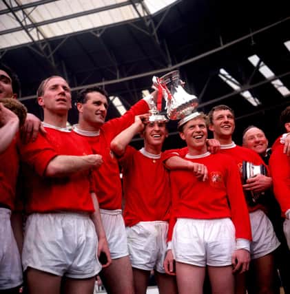 Manchester United players (left to right) Bobby Charlton, Noel Cantwell, Pat Crerand, Albert Quixall and David Herd celebrate with the FA Cup in 1963.