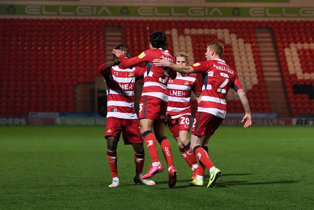Doncaster's Reece James celebrates his goal in front of the empty stands at the Keepmoat Stadium on Tuesday (Picture: Howard Roe)