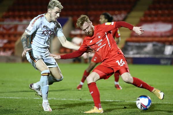 Leyton Orient's James Brophy holds off Bradford City's Tyler French during the League Two clash at The Breyer Group Stadium on Tuesday night. Picture:  Jacques Feeney/Getty Images.