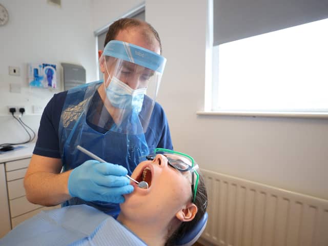 A dentist at work using personal protection equipment