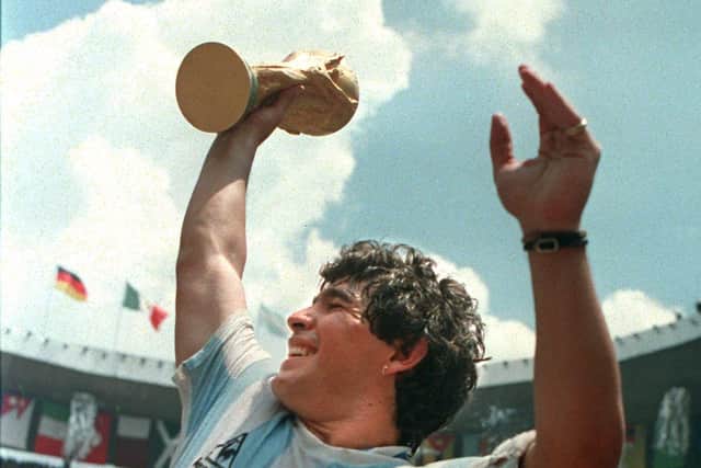 Argentina's soccer star team captain Diego Maradona brandishes the World Cup won by his team after a 3-2 victory over West Germany 29 June 1986 at the Azteca stadium in Mexico City.  (Picture: STAFF/AFP via Getty Images)